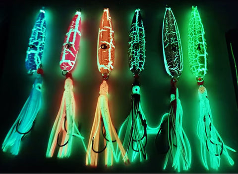 Glowing fishing lures in various colors on a dark background